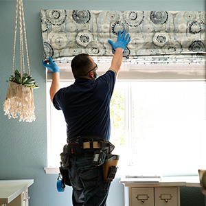 Let Our Installers do the Work Man Installing WIndow Treatments