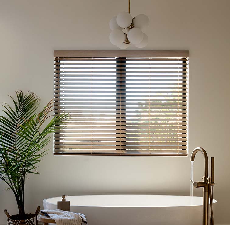 Faux Wood Blinds in a bathroom above a tub